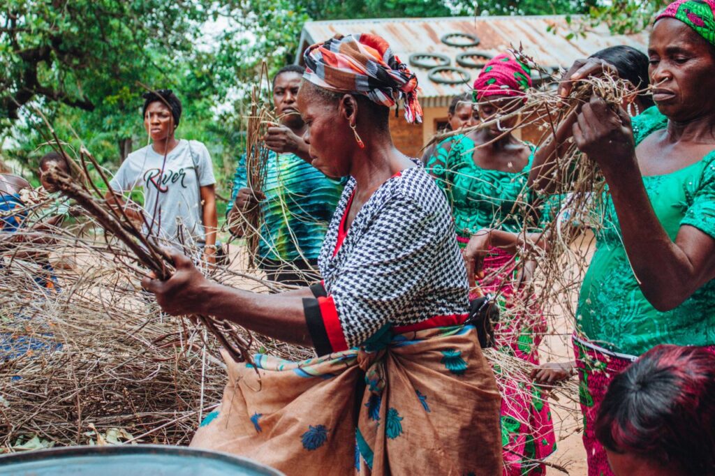 Women participating in a rural community activity, showcasing traditional culture and attire.
